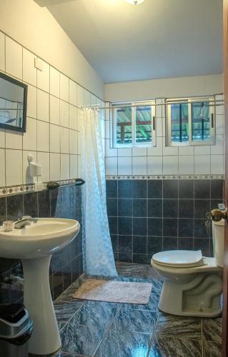 a bathroom with a sink and a toilet at Organic Garden in San José