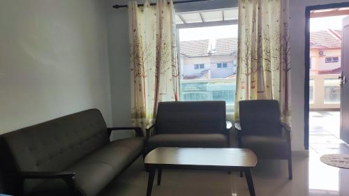 a living room with a couch and a table and a window at BBT Double Storey Balcony Bukit Tinggi Home in Klang