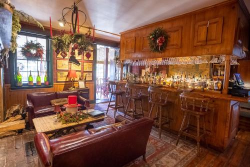 a bar with chairs and a table and a counter at Antrim 1844 in Taneytown