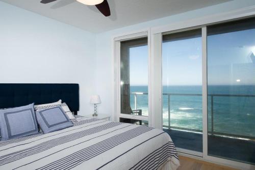 a bedroom with a bed with a view of the ocean at Whale Crossing in Depoe Bay