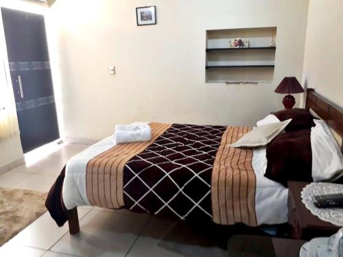 a bedroom with a large bed in a room at Nia in Tarija