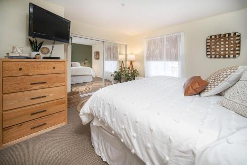 a bedroom with a bed and a dresser with a television at Waters Edge 304 in Lincoln City