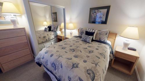 a bedroom with a bed and a large mirror at Waters Edge 308 in Lincoln City