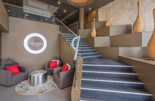 a staircase in a lobby with red pillows at Mercure Rockhampton in Rockhampton