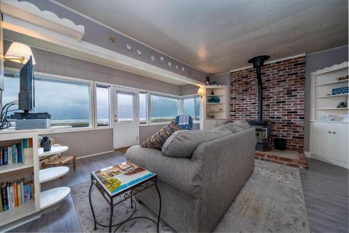 a living room with a couch and a brick wall at Beachside Bungalow in Rockaway Beach