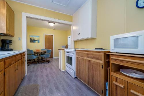 a kitchen with a microwave and a stove top oven at Beachside Bungalow in Rockaway Beach