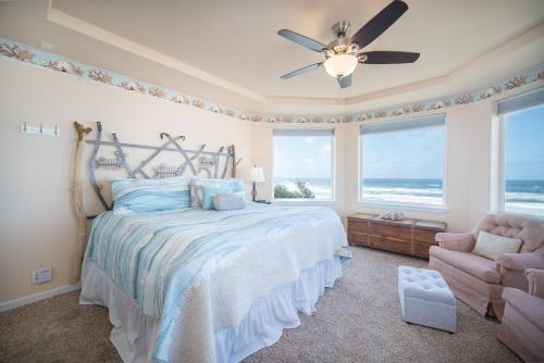 a bedroom with a bed and a fan and a chair at Beverly Beach Overlook in Newport