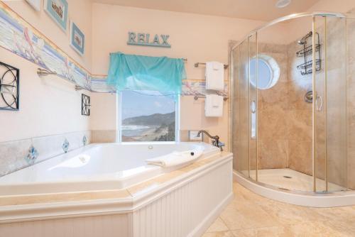a large bathroom with a tub and a shower at Beverly Beach Overlook in Newport