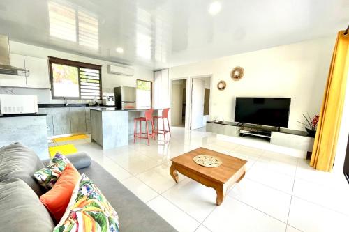 - un salon avec un canapé et une table dans l'établissement Muna house and private pool - AC - optic fiber Wi-Fi - 3 pers, à Punaauia