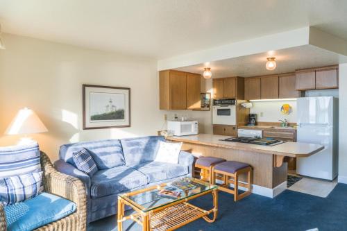 a living room with a couch and a kitchen at Dock of The Bay 105 in Lincoln City