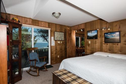 a bedroom with a bed and a chair and a window at Crows Nest in Newport