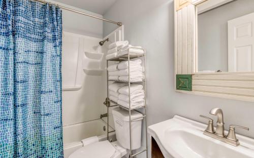 a bathroom with a sink and a toilet and a shower at The Strand at Twin Rocks in Rockaway Beach