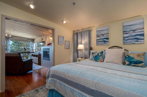 a bedroom with a bed and a living room at Tranquility Cove in Depoe Bay