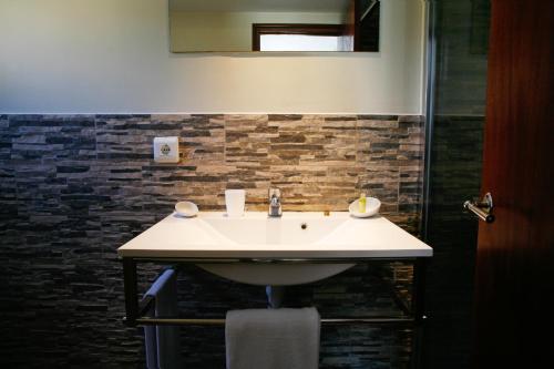 a bathroom with a sink and a shower at SEVEN Hostal in Cala Millor