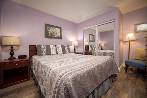 a bedroom with a large bed and a mirror at Waters Edge 207 in Lincoln City