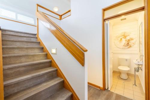 a staircase in a house with a toilet at The Moorings 18 4 Cromarty Rd Waterfront, Pool, Wifi & AirCon in Soldiers Point