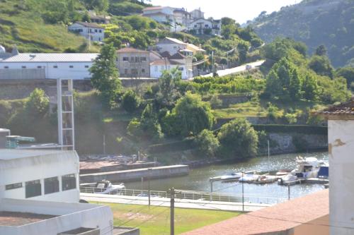 a view of a river with boats in it at Hotel Comércio in Resende