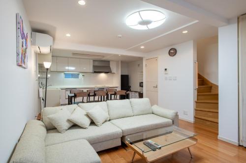 a living room with a couch and a table at 新宿6丁目戸建 in Tokyo