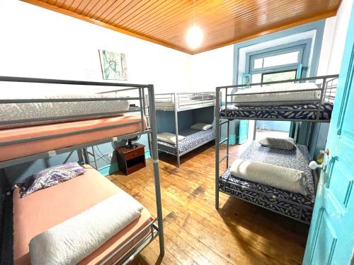 a room with four bunk beds and a door at Lisboa Parque Guest House in Lisbon