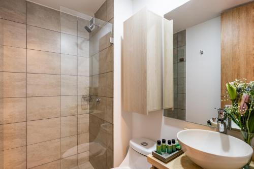 a bathroom with a sink and a shower at Cabrera 85 Apartments in Bogotá