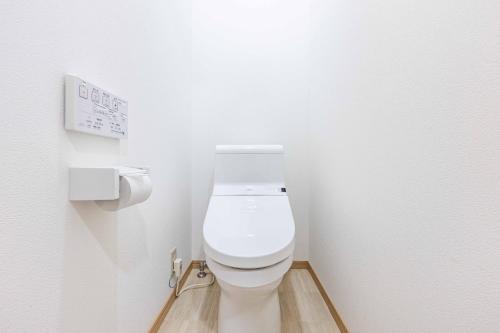 a bathroom with a white toilet in a stall at add-Hostel Uji Cha-gan-ju-tei in Uji