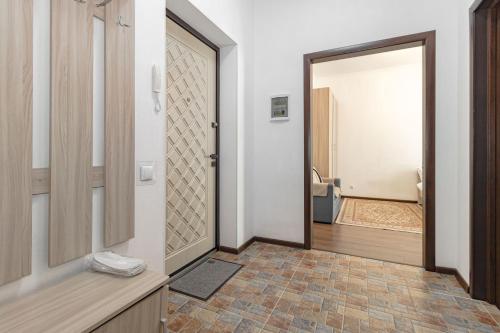 a bathroom with a door leading to a toilet at Уютная Квартира Expo Boulevar in Astana