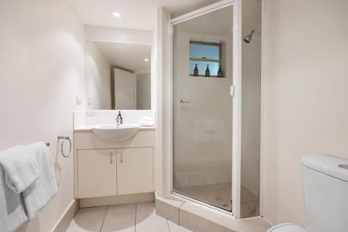 a bathroom with a shower and a sink at French Quarter Apartment 116, Noosa Heads in Noosa Heads