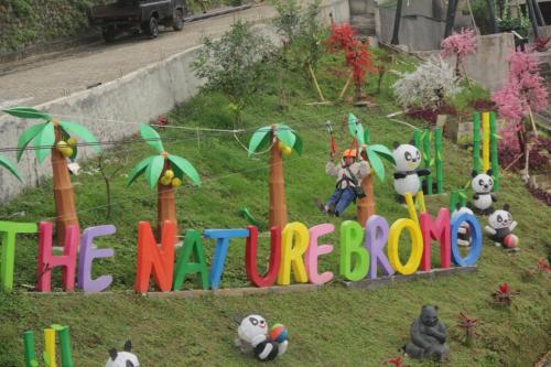 a sign that says the marvellous sitting in the grass at Hotel Nature Bromo and Resort in Pasuruan