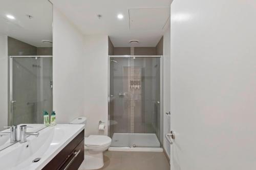 a bathroom with a shower and a toilet and a sink at Southbank Apartment with Skyline View: 5-Min Walk to CROWN Casino in Melbourne