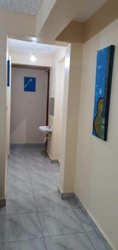 a hallway in an office with a painting on the wall at Tai Homes in Eldoret
