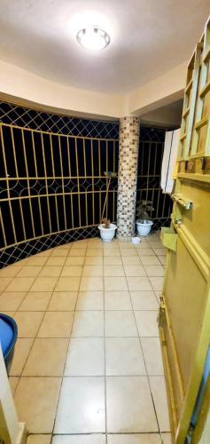 a bathroom with two toilets and a tiled floor at Tai Homes in Eldoret