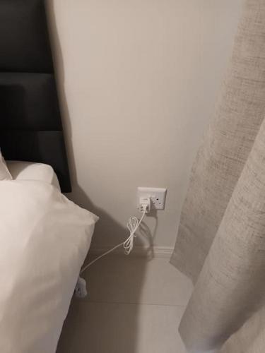 a bedroom with a bed and a white pillow at The Blissful Abode by BK Hospitable in Midrand