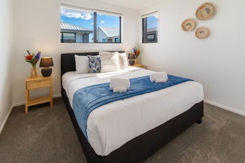 a bedroom with a large bed and a window at Coastal Sands Escape 1 bed 1 bath w/sofa bed in Christchurch