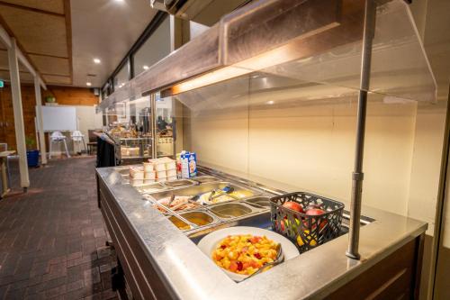 a kitchen with a counter with a plate of food at Hospitality Carnarvon, SureStay Collection by Best Western in Carnarvon