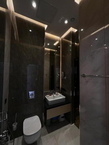 a bathroom with a toilet and a sink and a shower at Sea Breeze Lighthouse hotel in Nardaran
