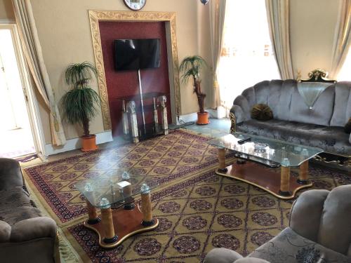 a living room with a couch and a table at Spinghar Royal Hotel in Jalalabad 