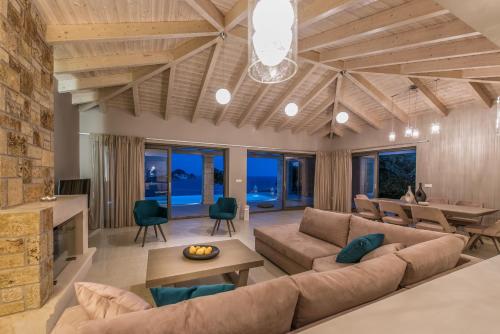 a living room with a couch and a table at Avra Luxury Villa & Spa in Keri