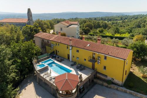 an aerial view of a yellow house with a swimming pool at Pool House Klarina - Happy Rentals in Pićan
