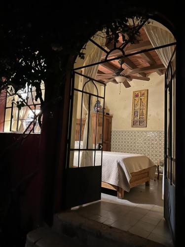 a bedroom with a bed and a glass doorway at Antigua Casa del Limon in Guanajuato