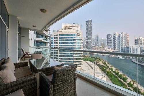 a balcony with a view of a city skyline at Dubai Marina 2BR Beach Oasis in Dubai