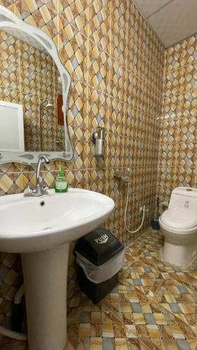 a bathroom with a sink and a toilet at Bidiya Desert Camp in Aflāj