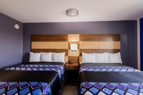 a hotel room with two beds in a room at Coratel Inn & Suites by Jasper Inver Grove Heights in Inver Grove Heights