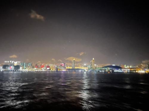 a view of a city at night from the water at Waterlife in Lisbon