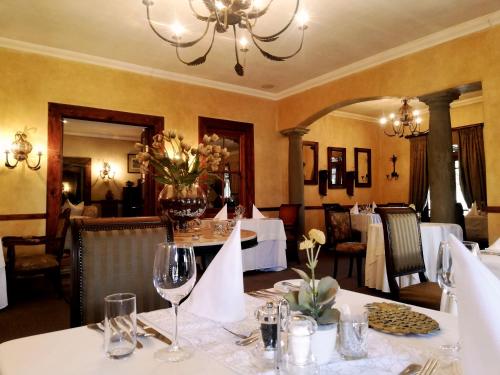 a dining room with a table with wine glasses at Dawsons Game Lodge in Badplaas