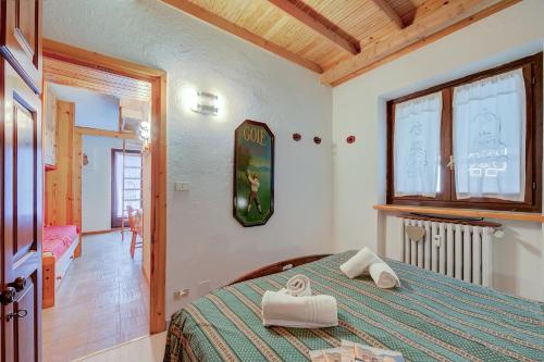 a bedroom with a bed with two towels on it at Appartamento Rochebrune 200m from Ski - Happy Rentals in Claviere