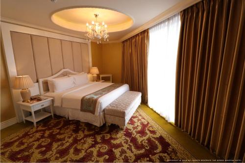 a bedroom with a large bed and a large window at The Grand Kandyan in Kandy