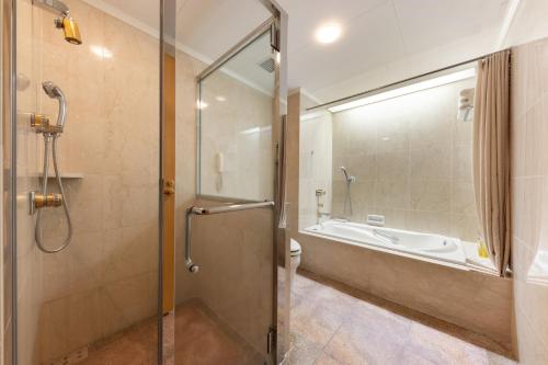 a bathroom with a shower and a toilet and a tub at ANA Crowne Plaza Toyama by IHG in Toyama