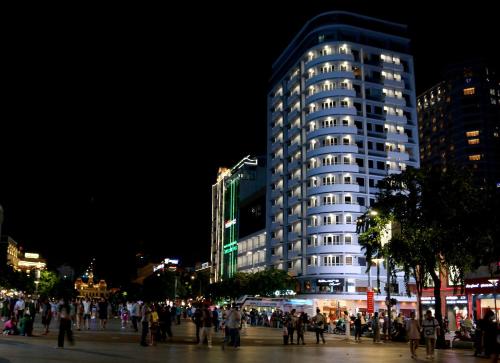 a group of people standing in front of a building at Palace Hotel Saigon in Ho Chi Minh City