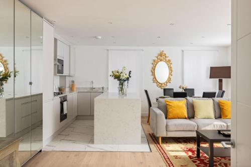 a living room with a couch and a table at Kensington High Street Apartments in London