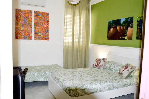 a small bedroom with a bed and a couch at Don Mimí l'affittacamere in Messina